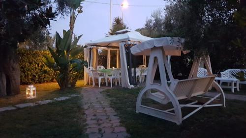a yard with a gazebo and chairs at night at Residence Alba in Vieste