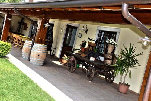 a covered porch with a horse drawn cart on it at Agriturismo La Rosta in Cervignano del Friuli