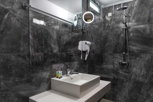 a bathroom with a sink and a shower at Atalanti Boutique Hotel - Adults Only in Faliraki