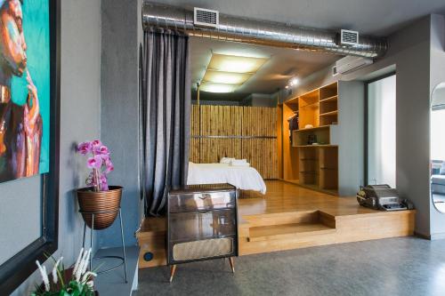 a bedroom with a bed and a large mirror at Artists’ favorite Spacious Loft near Acropolis!! in Athens