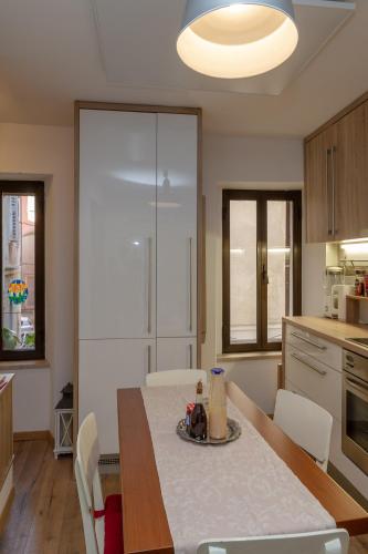 a kitchen with a table and chairs and a kitchen with a table and a table at Nono Mario in Piran
