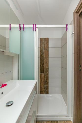 a white bathroom with a shower and a sink at Nono Mario in Piran