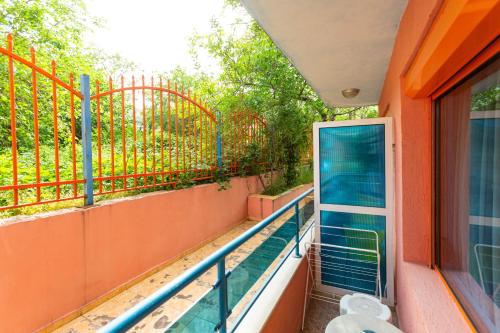 a balcony with a glass door and a fence at Family Hotel Jemelly in Obzor