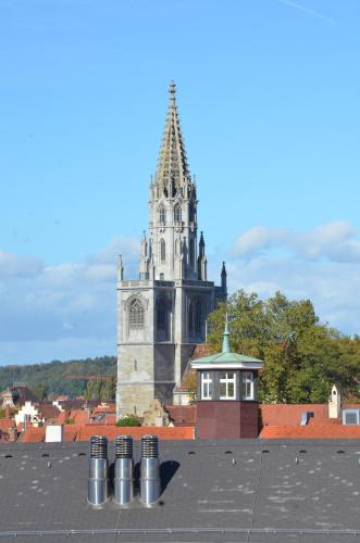 a building with a clock tower in the background at Gästehaus Centro in Konstanz in Konstanz