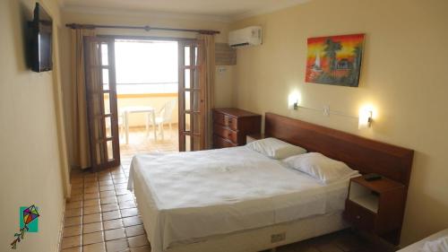 Ένα ή περισσότερα κρεβάτια σε δωμάτιο στο Hotel Morro do Careca
