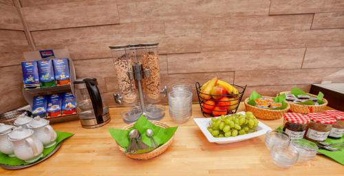 a table with fruits and other food items on it at Hotel Landgasthof Hölzer in Fröndenberg
