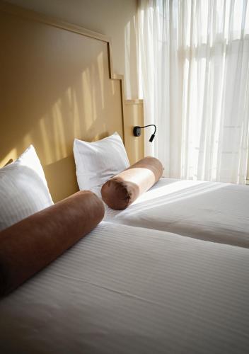 a pair of legs laying on beds in a hotel room at The Times Hotel in Amsterdam