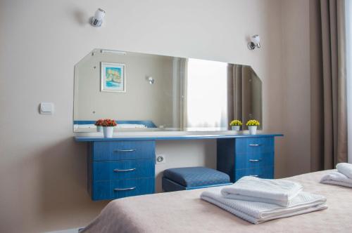 a bathroom with a blue vanity and a mirror at Ana's Place in Kotor