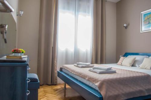 a bedroom with a bed with towels on it at Ana's Place in Kotor