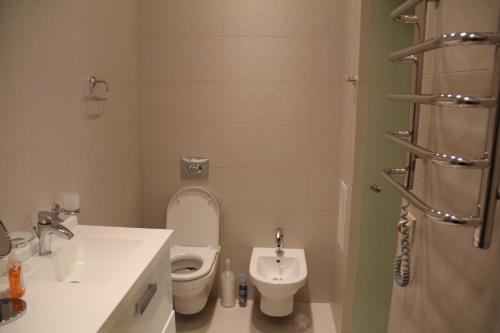 a bathroom with a toilet and a bidet at Apartment in Center of Odessa in Odesa