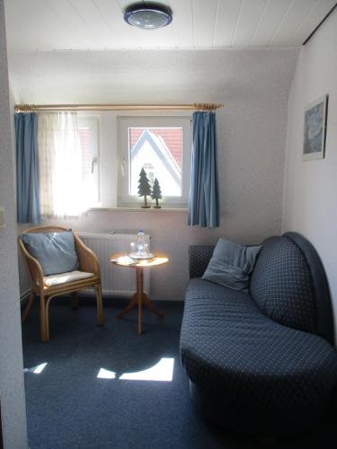 a living room with a couch and a table at Villa Tannerhof in Braunlage