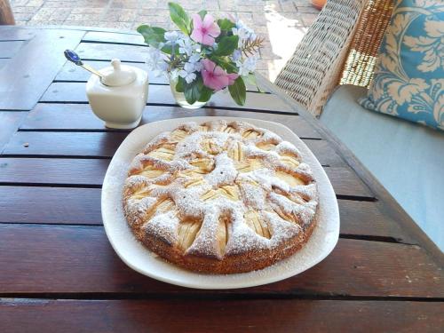 a pie on a plate on a wooden table at Khashamongo B & B in Somerset West