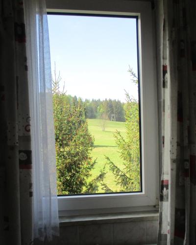 a window in a bathroom with a view of a field at Villa Tannerhof in Braunlage