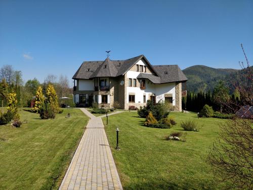 a house with a brick path in front of it at Садиба "Градний Узвіз" in Tatariv