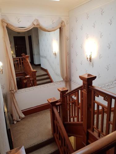 a room with a staircase and a room with a stair case at Hamilton House in Dumfries