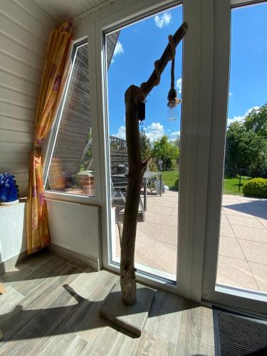 a tree limb standing in front of a door at Ferienhaus nähe Warnemünde 3 in Elmenhorst