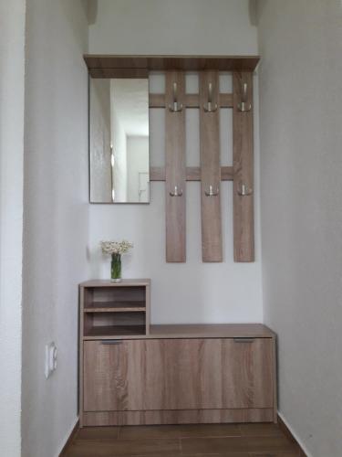 a bathroom with a mirror and a wooden cabinet at Domaćinstvo Krstajić - Rural holiday in Žabljak