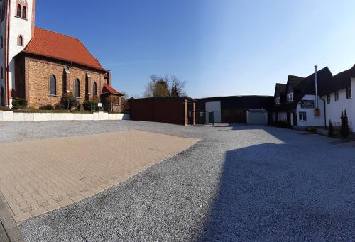 an empty parking lot in front of a church at Hotel Landgasthof Hölzer in Fröndenberg