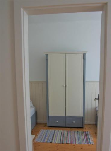 an empty room with a glass cabinet and a rug at Stieglerhof KG in Illmitz
