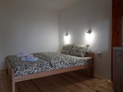 a small bedroom with a bed with two pillows at Domaćinstvo Krstajić - Rural holiday in Žabljak
