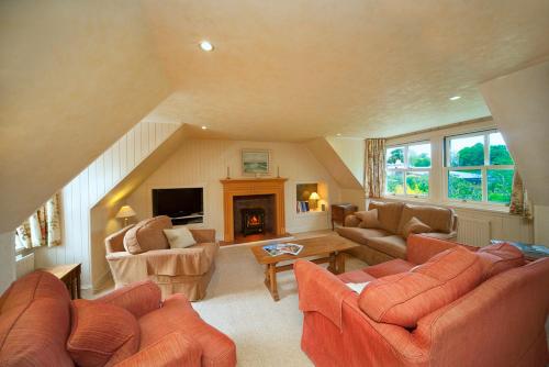 a living room with orange furniture and a fireplace at Isle of Eriska Hotel Spa & Island in Benderloch
