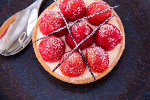 a cake with strawberries on top of it on a table at Rowhill Grange Hotel & Utopia Spa in Dartford
