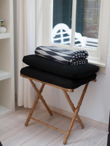 a chair with a blanket on top of it at Darley's in Hilversum