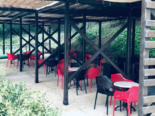 a group of tables and chairs under a pergola at Jezero Kudrec in Smederevska Palanka