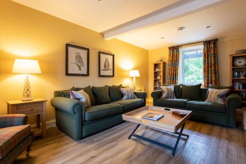 a living room with two couches and a coffee table at Isle of Eriska Hotel Spa & Island in Benderloch