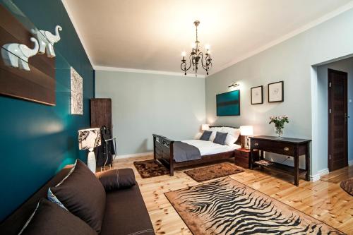 a living room with a bed and a table at Apartamenty Grunwaldzkie in Bydgoszcz