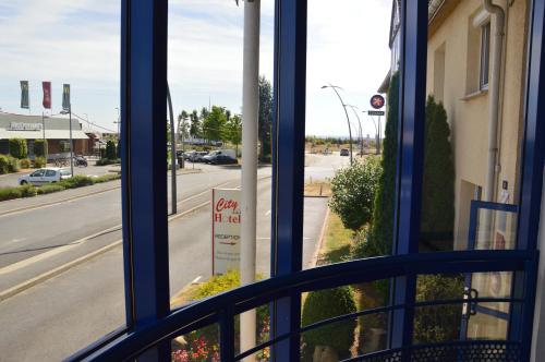 a view of a street from a bus window at The Originals City Hôtel, Aéroport Beauvais in Beauvais