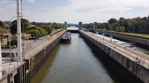 a boat is docked in a canal next to a bridge at Haus Anna Elbe, Bauernhaus-Ferienwohnungen an der Elbe in Hamburg
