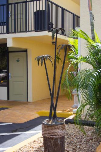 a statue of a plant in front of a building at At Home Inn - Fort Pierce in Fort Pierce