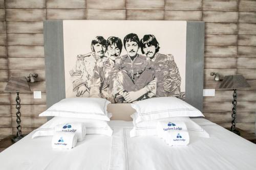 a bed with a picture of a group of men at Surfers Lodge Peniche in Peniche