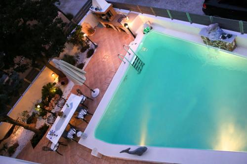 an overhead view of a swimming pool at night at Chris Villa in Perdhika