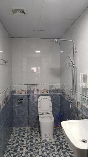 a bathroom with a toilet and a sink at Xuan Thanh Hotel in Thanh Hóa