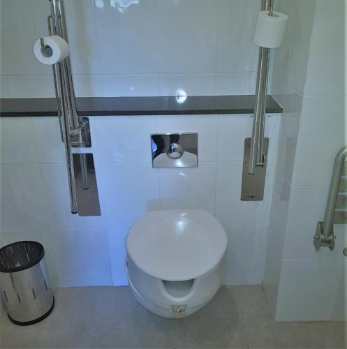 a bathroom with a white toilet and a trash can at Holiday Inn Express Molins de Rei by IHG in Molins de Rei