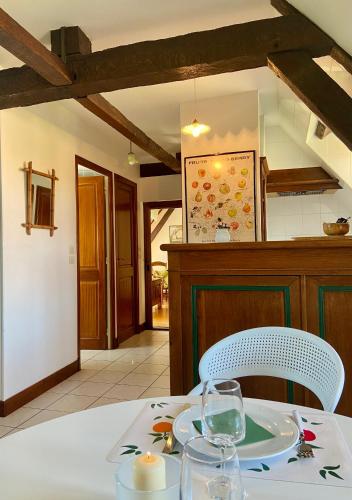 a table with a plate and a glass on it at Studio Le Gachet in Pouligny-Notre-Dame