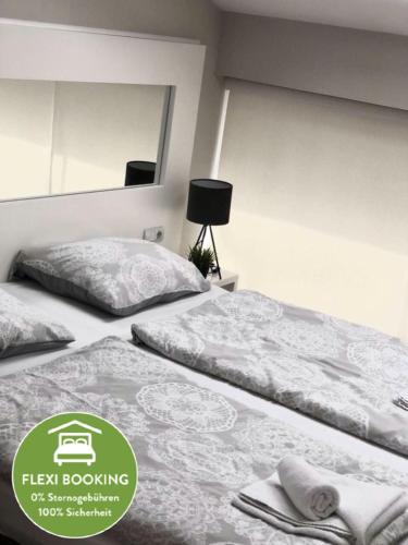 two beds in a room with a sign that says heal booking at Executive Rooms and Suites Play in Veliko Tŭrnovo