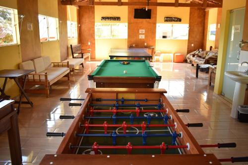 a room with several pool tables in a room at Pousada Colonetti in Lindóia