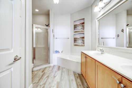 a bathroom with a tub and a sink and a shower at Dunes of Seagrove Condos in Santa Rosa Beach