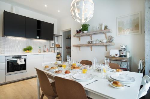 a dining room with a white table with food on it at Family Apartment in Tallinn