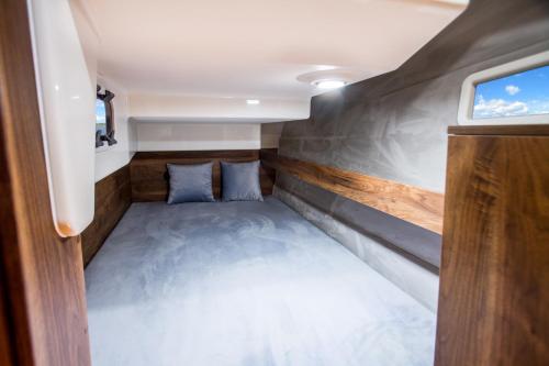 małe łóżko z tyłu domku w obiekcie Jacht motorowy Balt Tytan 1018 Fly w mieście Wilkasy