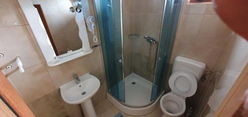 a bathroom with a shower and a toilet and a sink at LA CANAPELE ROCK in Vama Veche