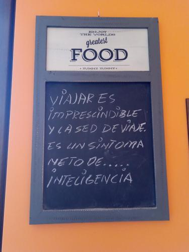 a chalkboard with food written on it on a wall at La Posada de Toribia in Val de San Lorenzo