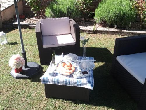 a picnic table with a plate of food on it at La Posada de Toribia in Val de San Lorenzo
