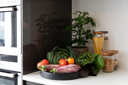 a bowl of vegetables sitting on top of a counter at 56 Welbeck Street in London