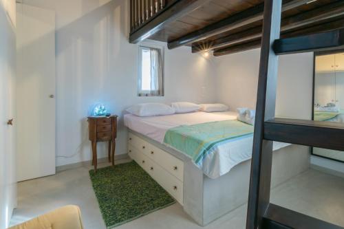 a bedroom with a bed and a dresser and a window at Komia Sea View Traditional in Komia