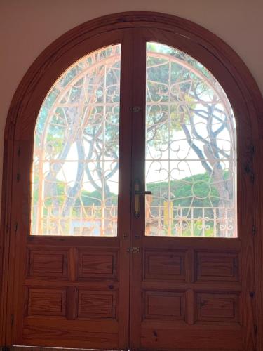 a wooden door with a stained glass window at La Quinta - La Barrosa in Chiclana de la Frontera