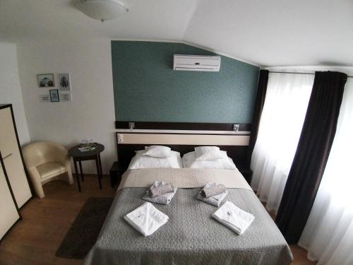 a hotel room with two beds and a green wall at A16 Design Panzió in Harkány